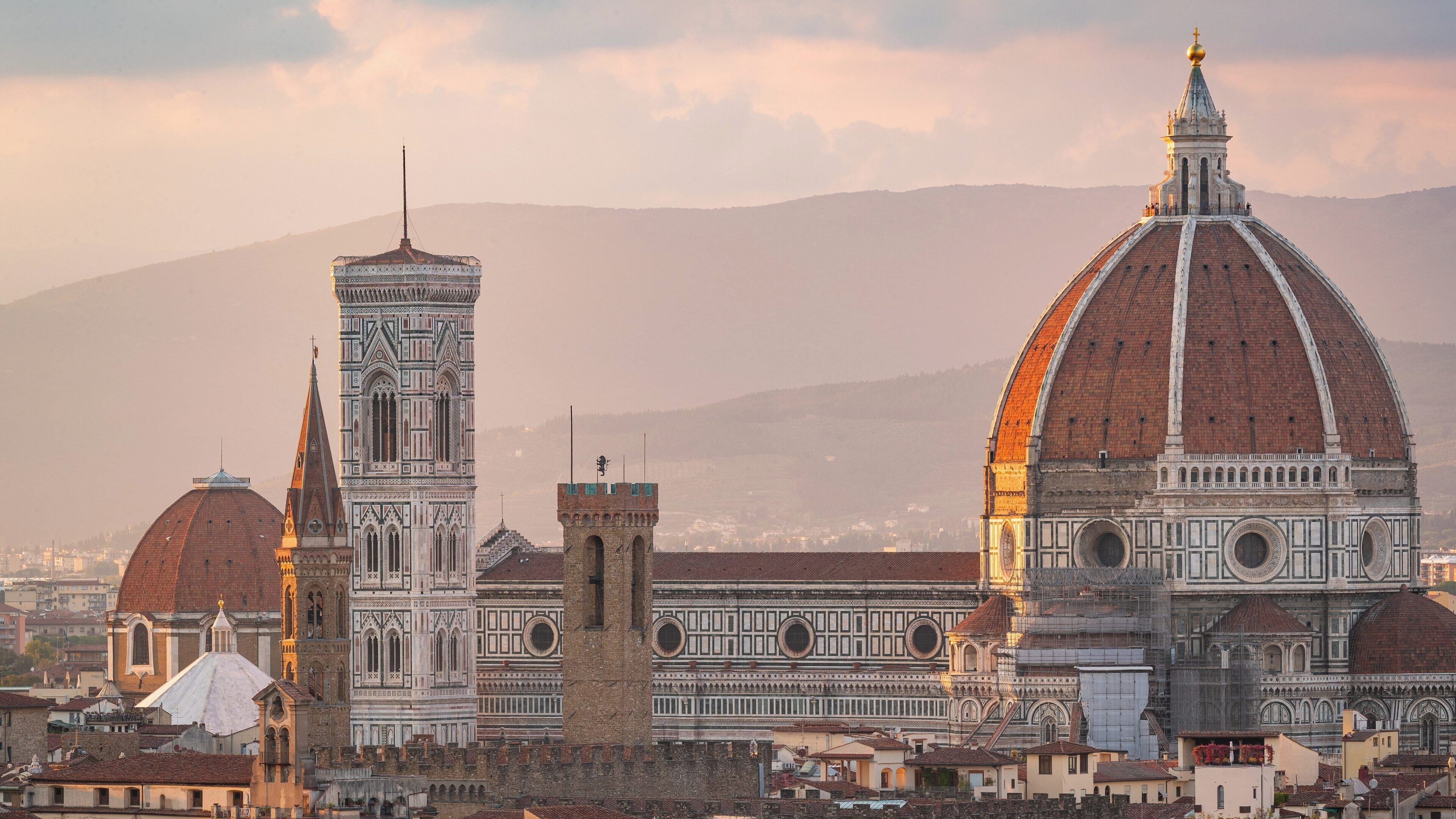 Cathedral of Santa Maria del Fiore stands majestically in Florence, showcasing stunning architecture under a soft golden sky