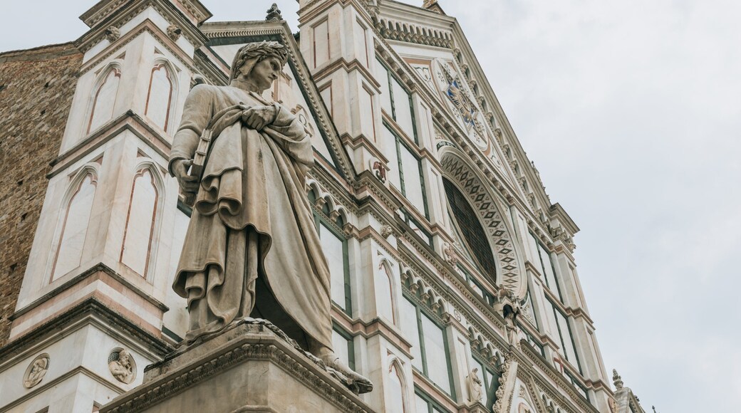 Basilica of Santa Croce showing a statue or sculpture, a church or cathedral and heritage elements