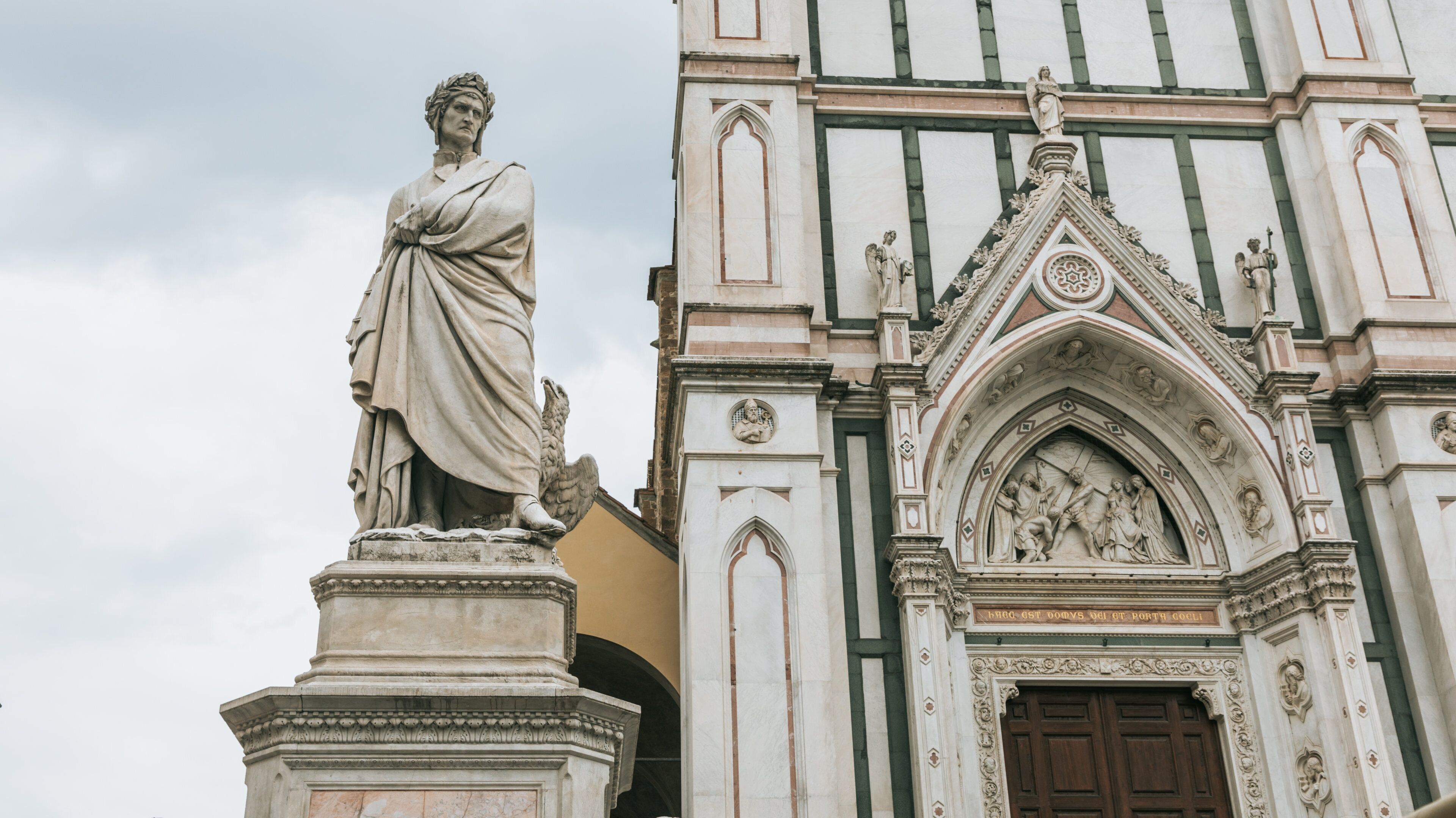 Basilica of Santa Croce showing a statue or sculpture, heritage architecture and a church or cathedral