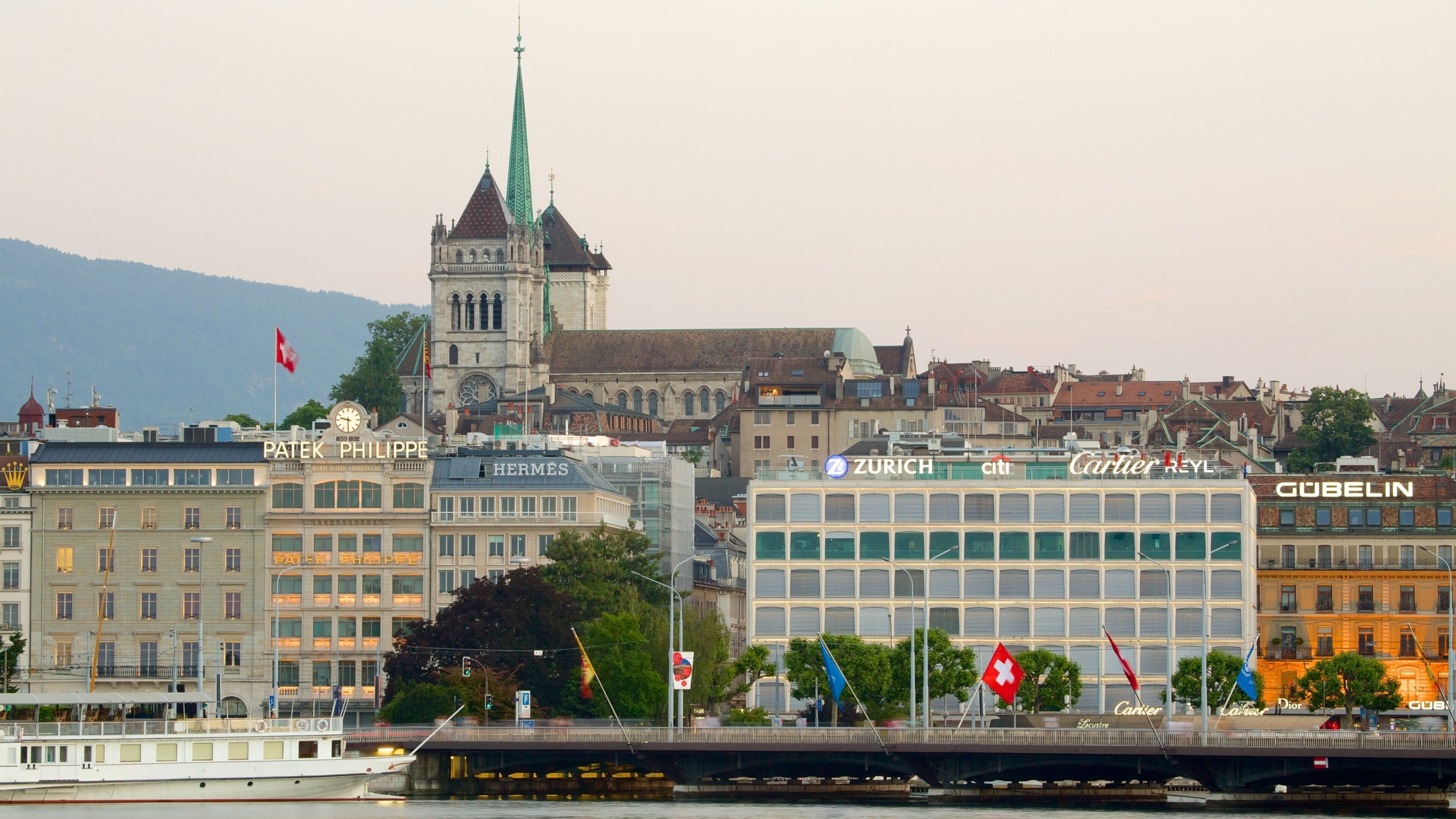 A cityscape with prominent buildings, including a clock tower and a modern glass structure.