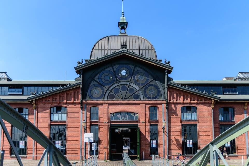 A historic building with a large dome and intricate clock face.