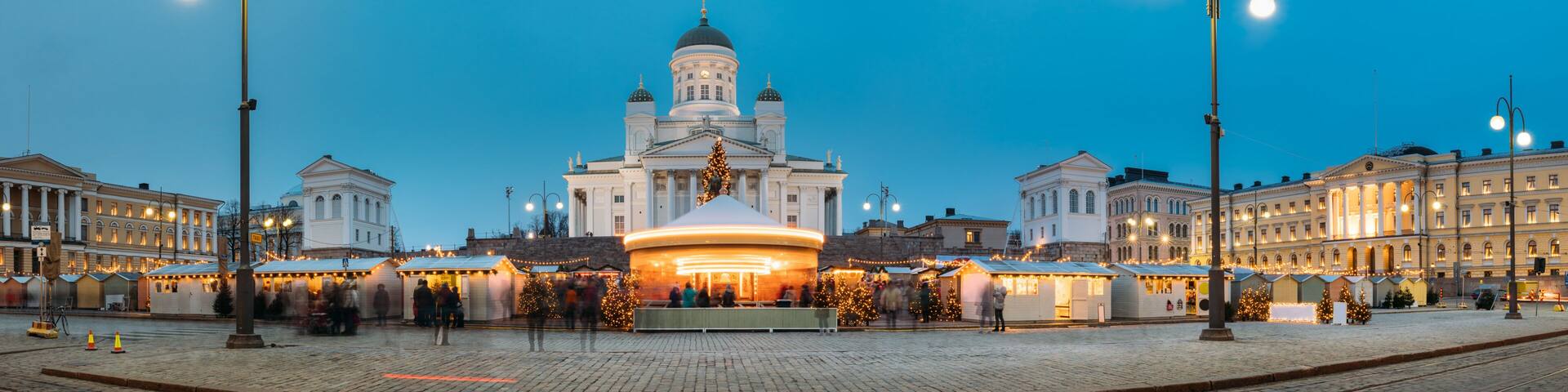 Helsinki, Finland. Market On Senate Square With Holiday Carousel And Famous Landmark Is Lutheran Cathedral In Winter Night