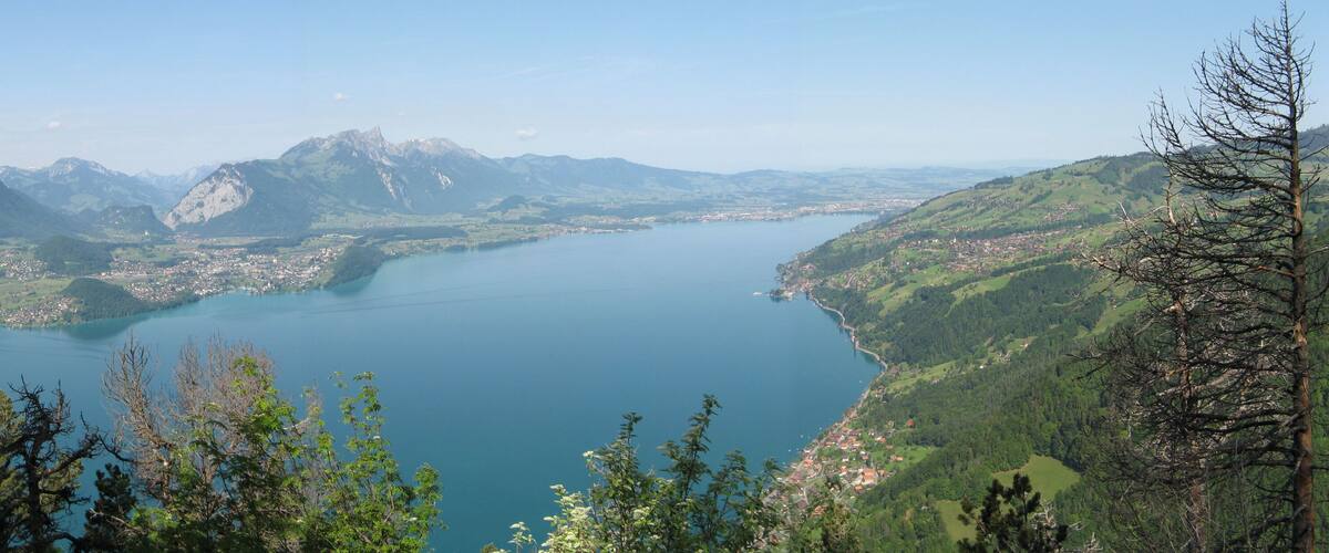 A lake surrounded by mountains and a town.