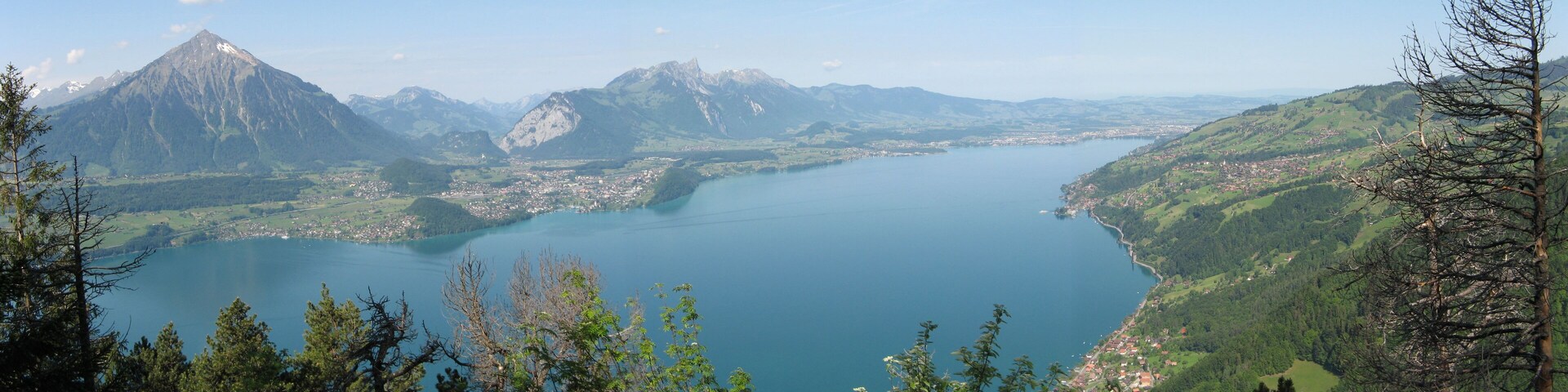 A lake surrounded by mountains and a town.