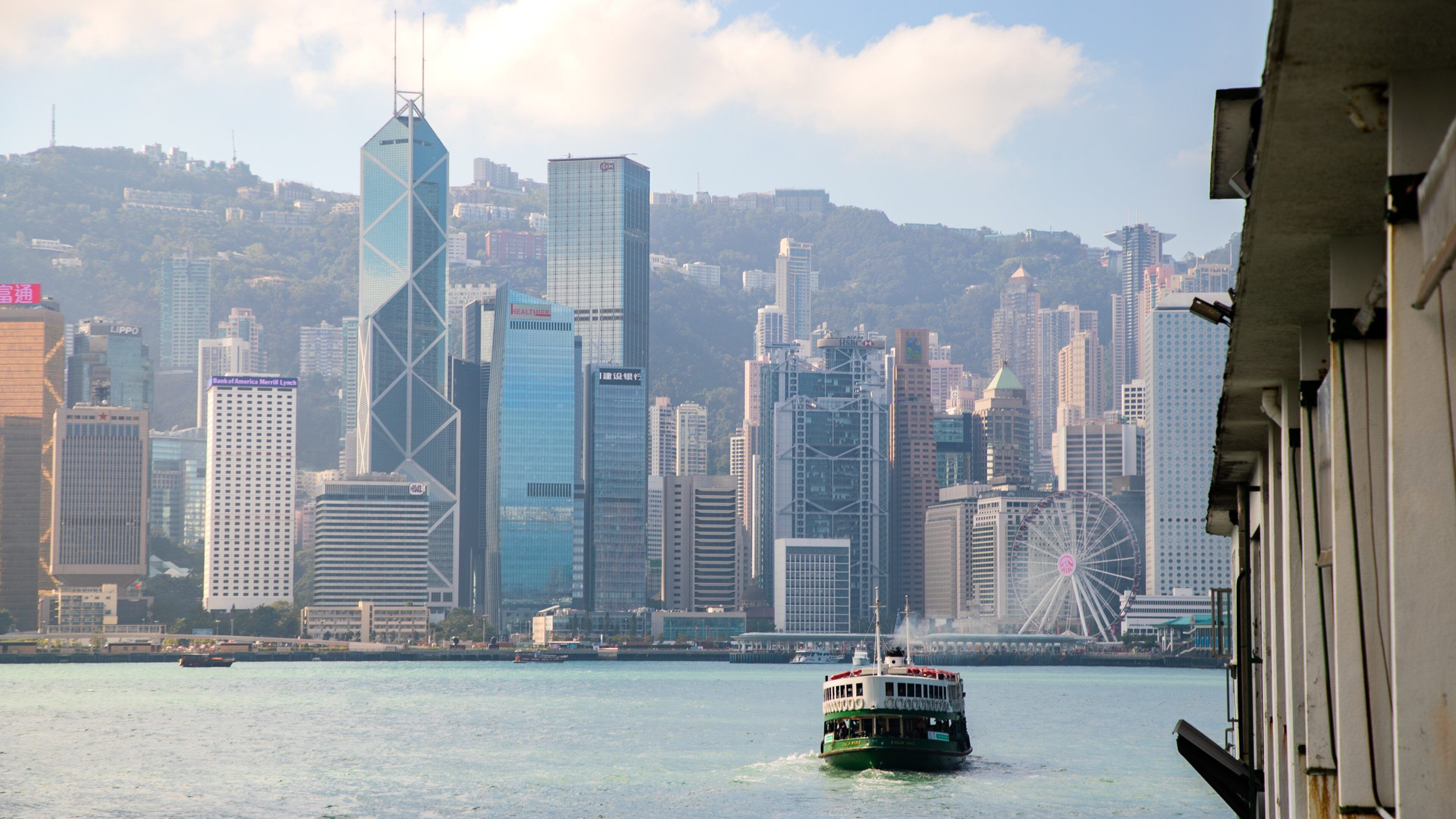Tsim Sha Tsui Star Ferry Pier featuring a ferry, a bay or harbor and a city