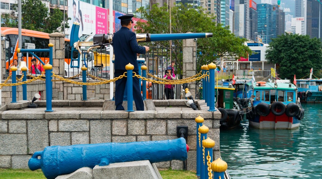 Noon Day Gun which includes a bay or harbor, heritage elements and military items