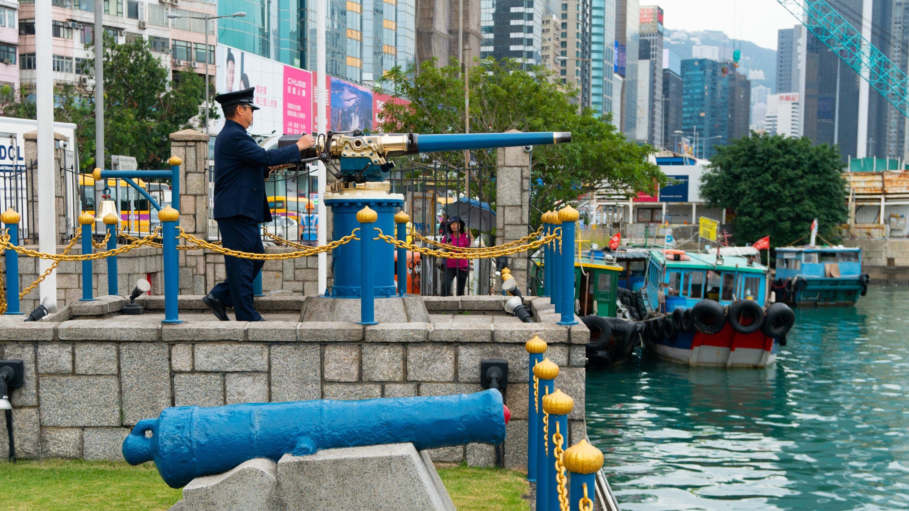 Noon Day Gun showing military items, a bay or harbor and heritage elements
