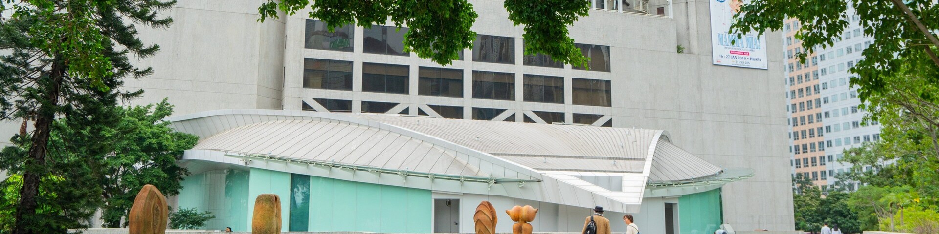 Hong Kong Academy for Performing Arts showing outdoor art and street scenes as well as a couple