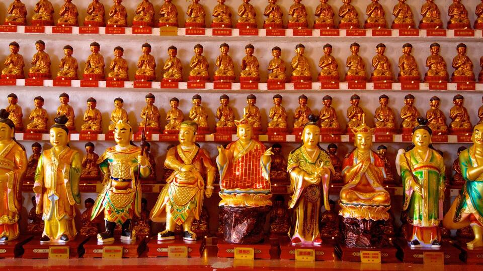 Rows of golden Buddha statues in a temple.