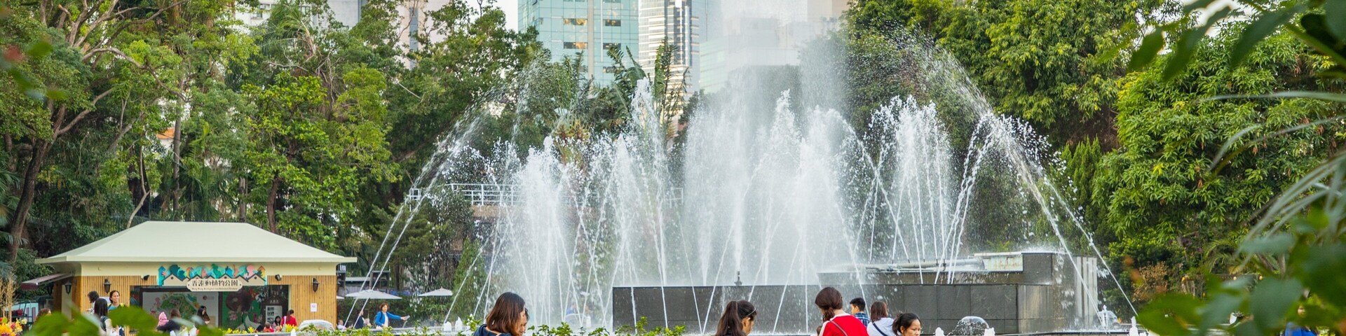 Hong Kong Zoo and Botanical Gardens featuring a fountain and a park as well as a family