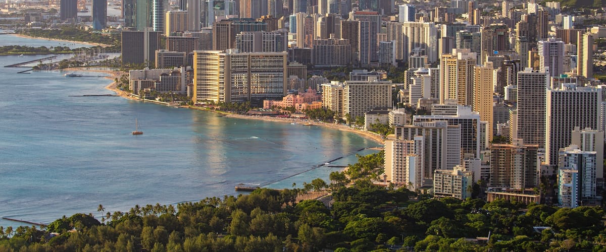 Diamond Head which includes a city, landscape views and a sunset