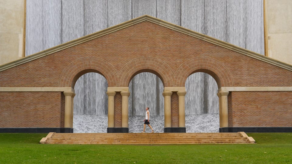 Man at the famous Water Wall in Houston, Texas USA