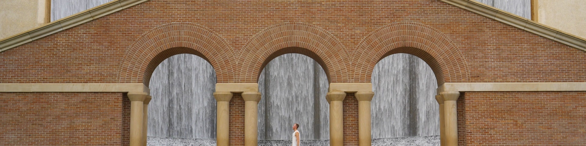 Man at the famous Water Wall in Houston, Texas USA