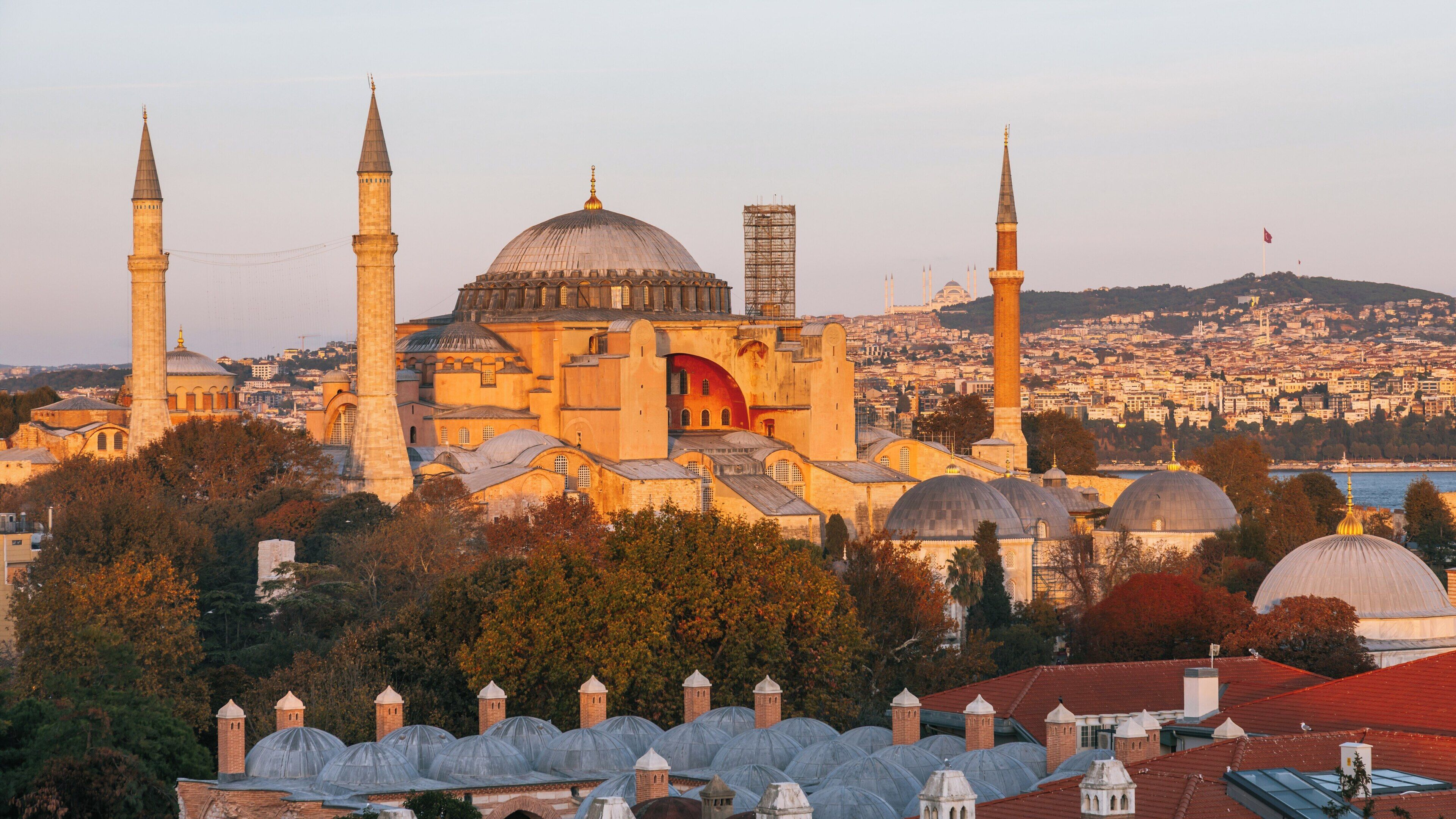 Blue Mosque rises majestically against the Istanbul skyline at sunset, showcasing its distinct architecture and historical significance to the city
