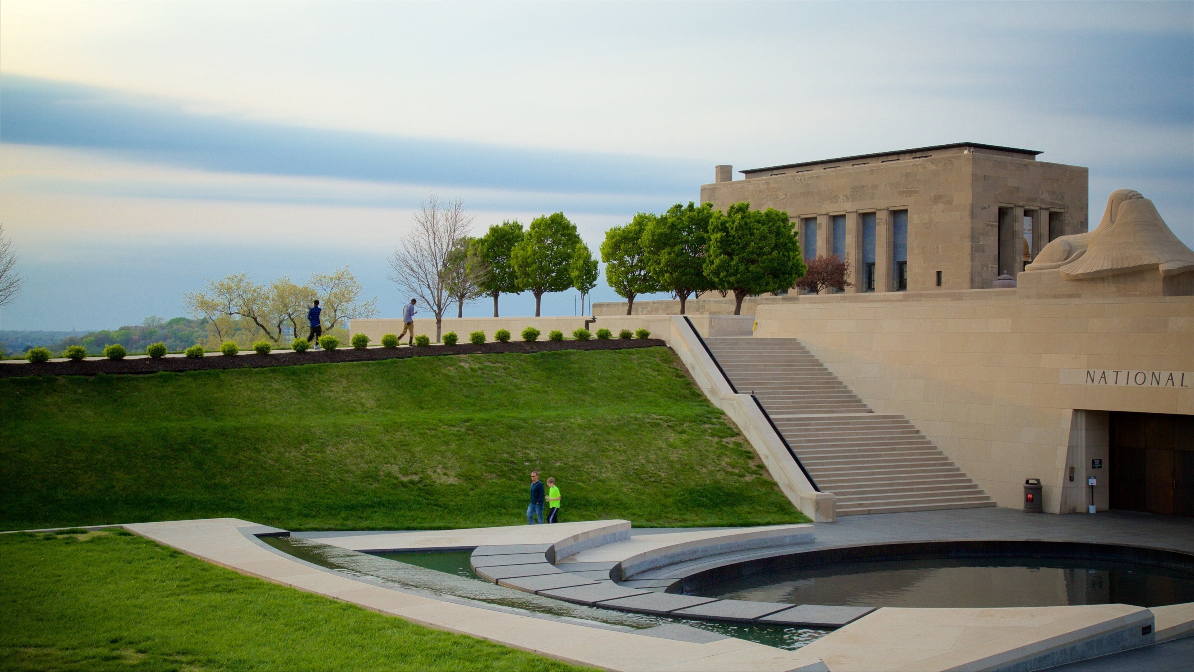 A landscaped area with a pool, a building labeled 'NATIONAL', and a staircase leading up to the building.