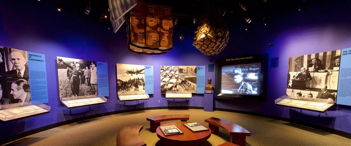 A museum exhibit with historical photographs and information panels.