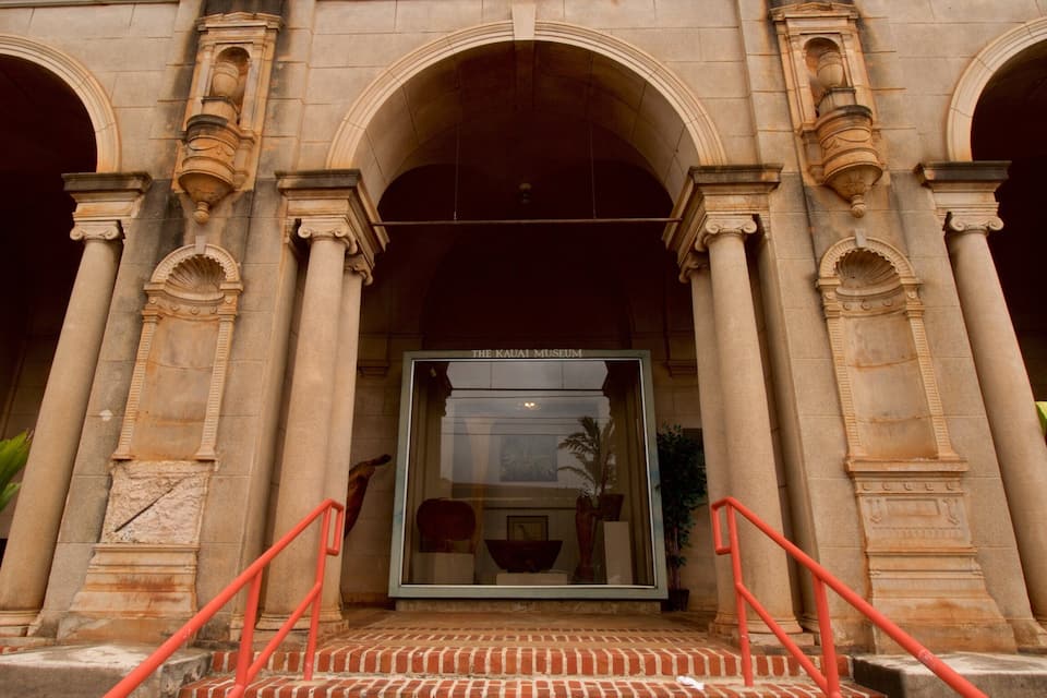The Kauai Museum entrance with classical architecture, including arches and columns.