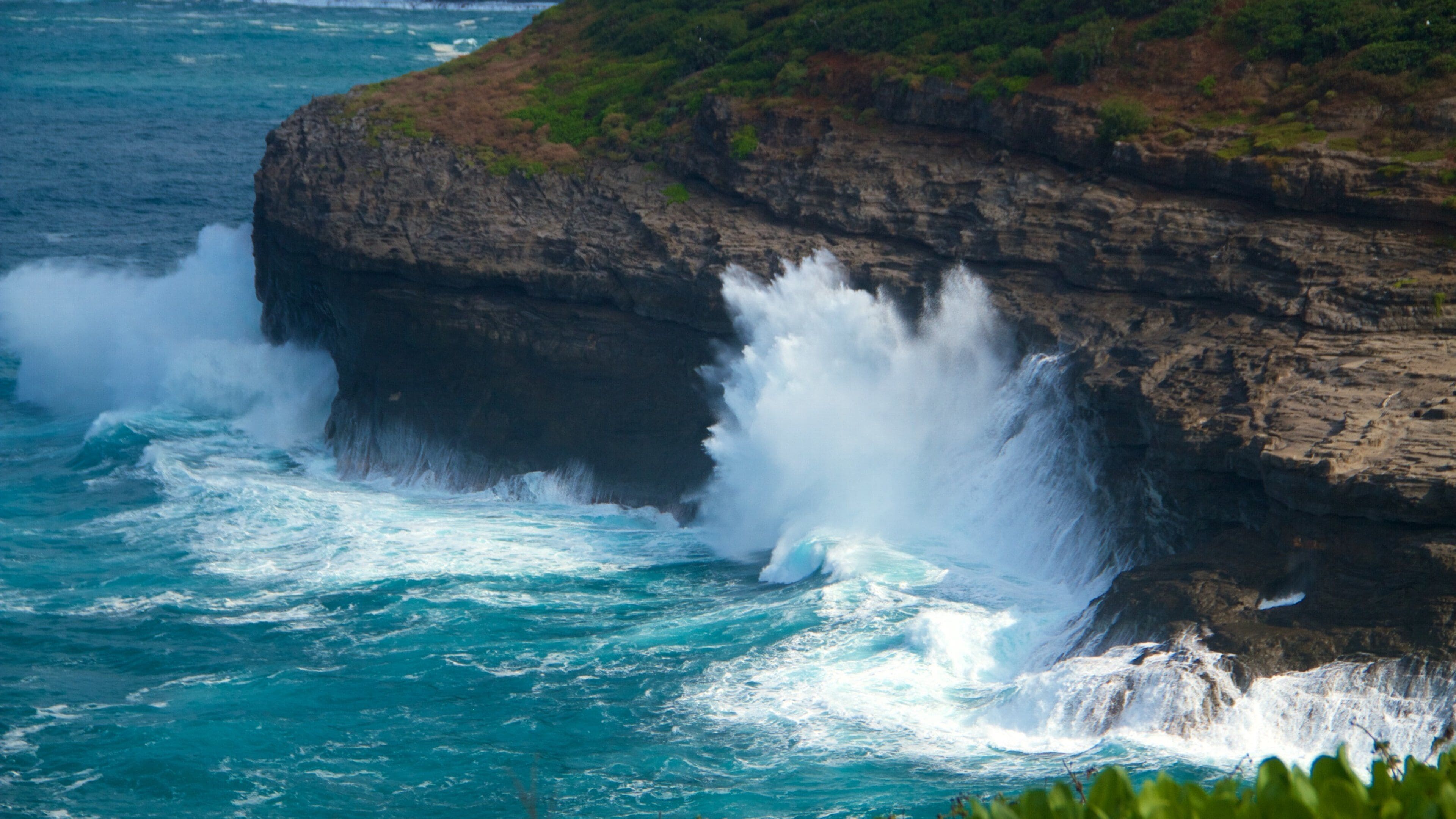 A rocky coastline with waves crashing against the cliffs.