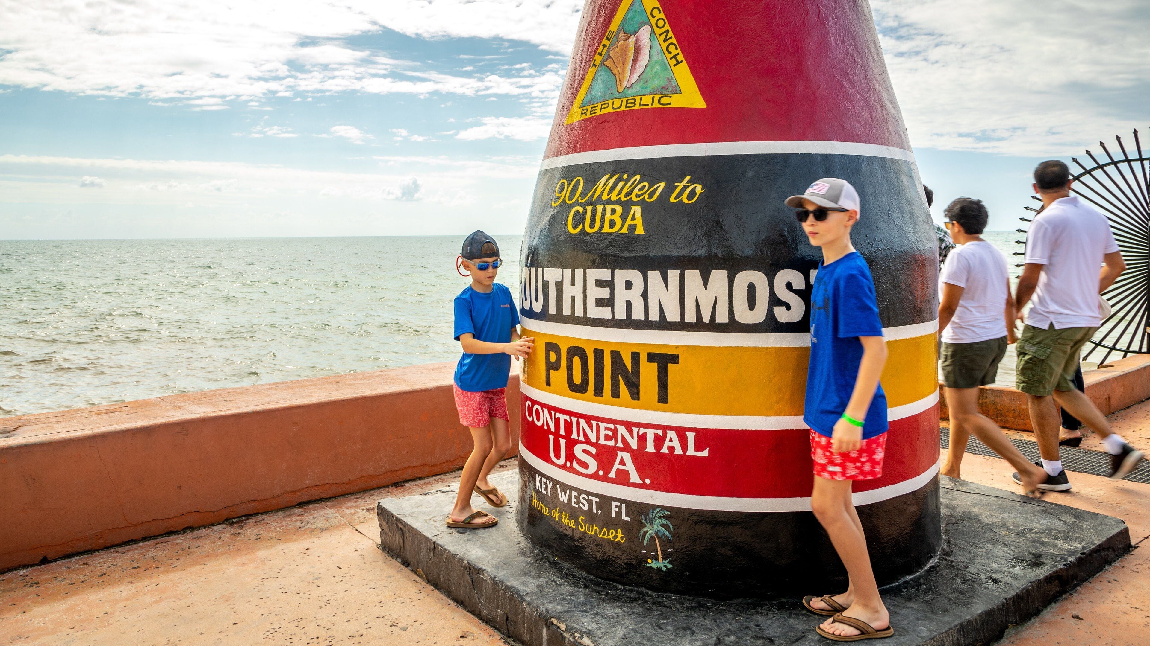 Southernmost Point which includes signage and general coastal views as well as children