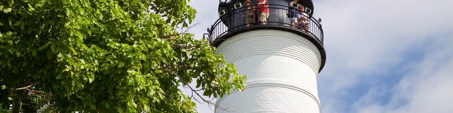 Key West Lighthouse and Keeper\'s Quarters Museum which includes a lighthouse as well as a small group of people