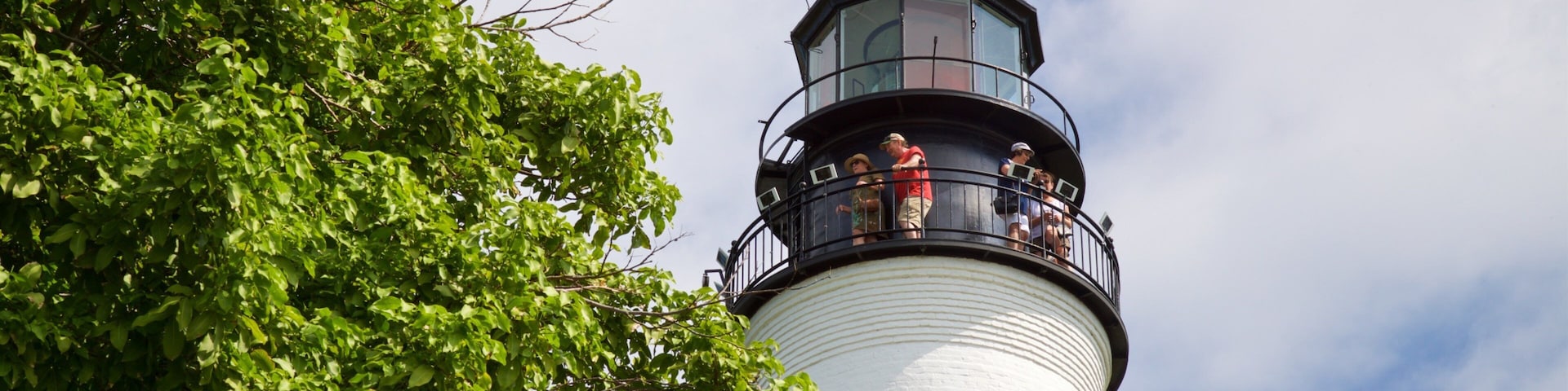 Key West Lighthouse and Keeper\'s Quarters Museum which includes a lighthouse as well as a small group of people