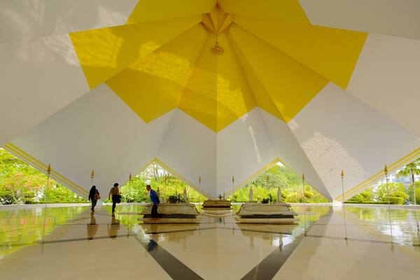 A large, white and yellow star-shaped ceiling with a central chandelier.