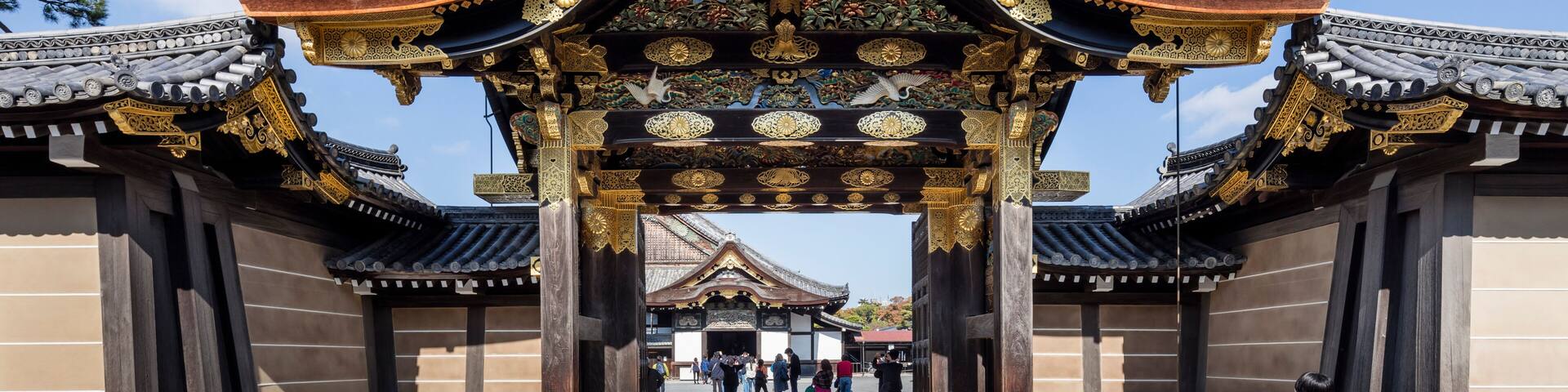 A traditional gate with ornate decorations and a clear blue sky above.