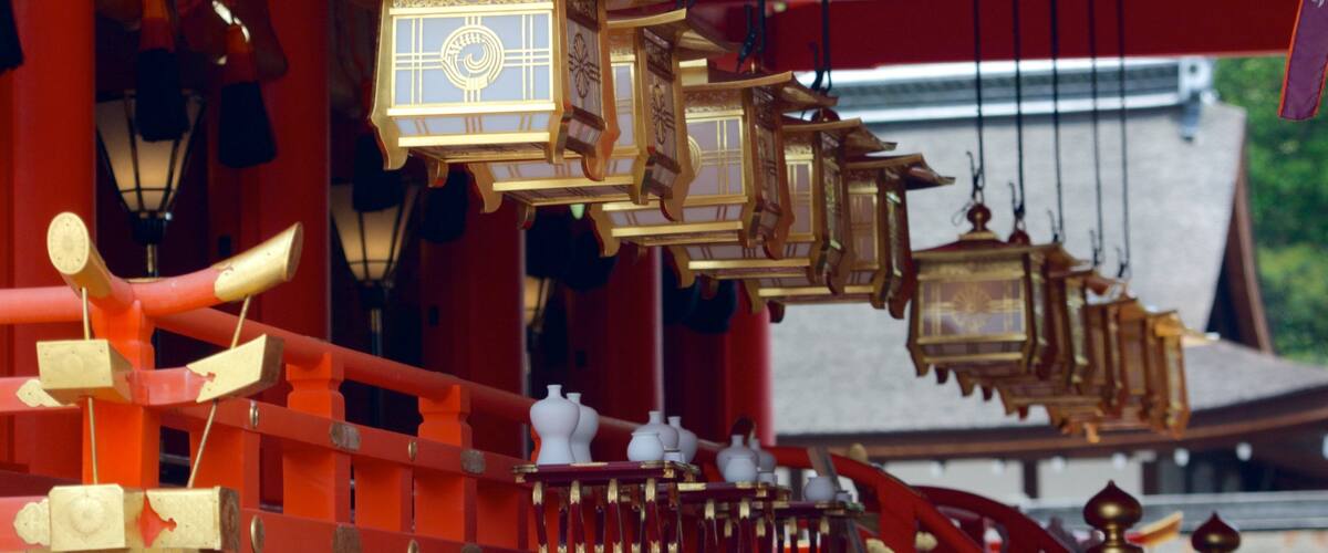 A traditional red and gold structure with hanging lanterns.