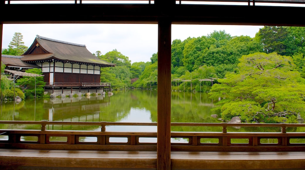 Heian Shrine featuring a temple or place of worship, a pond and a park