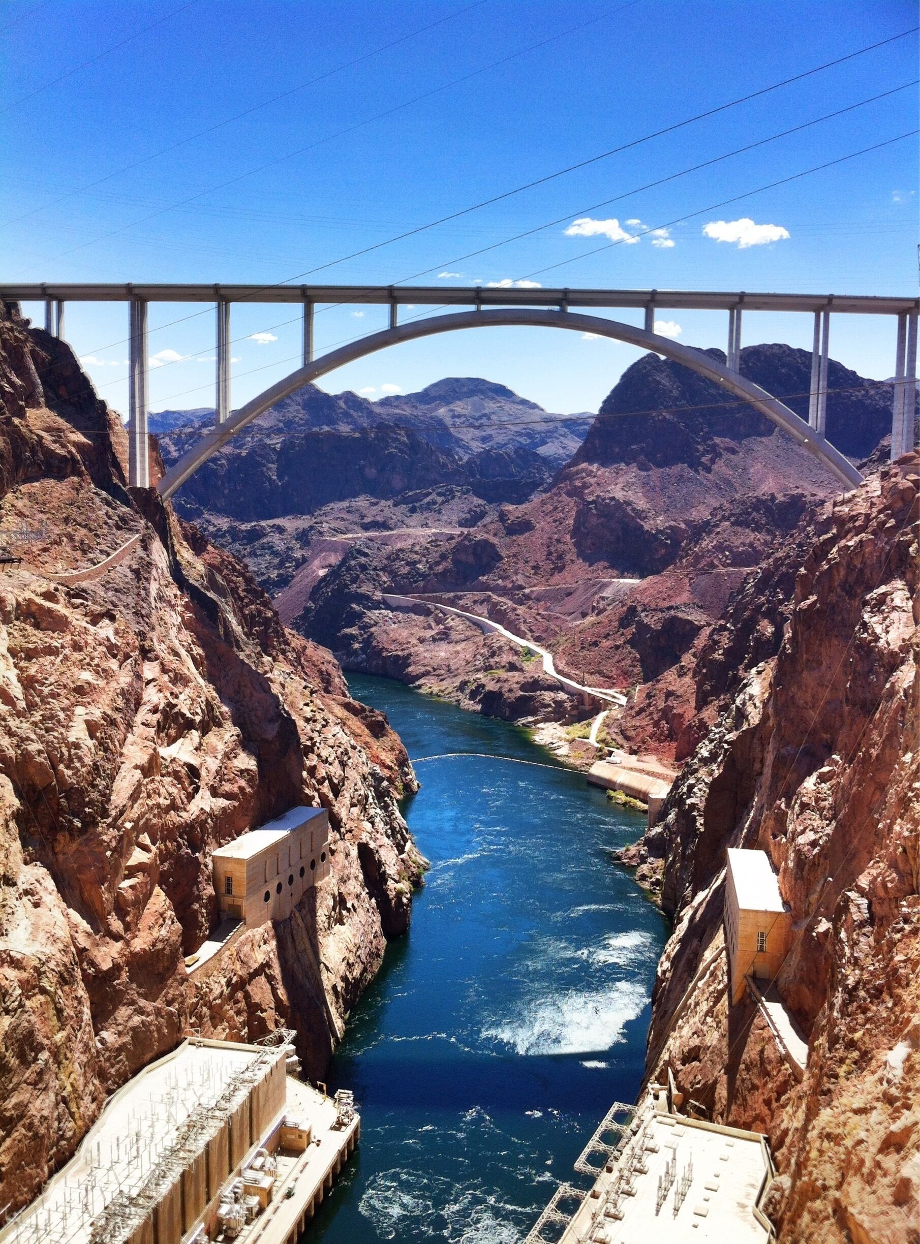 A bridge over a canyon with a river below.