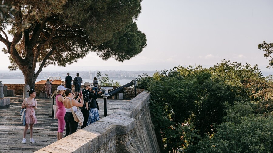 Castle of São Jorge featuring views as well as a small group of people