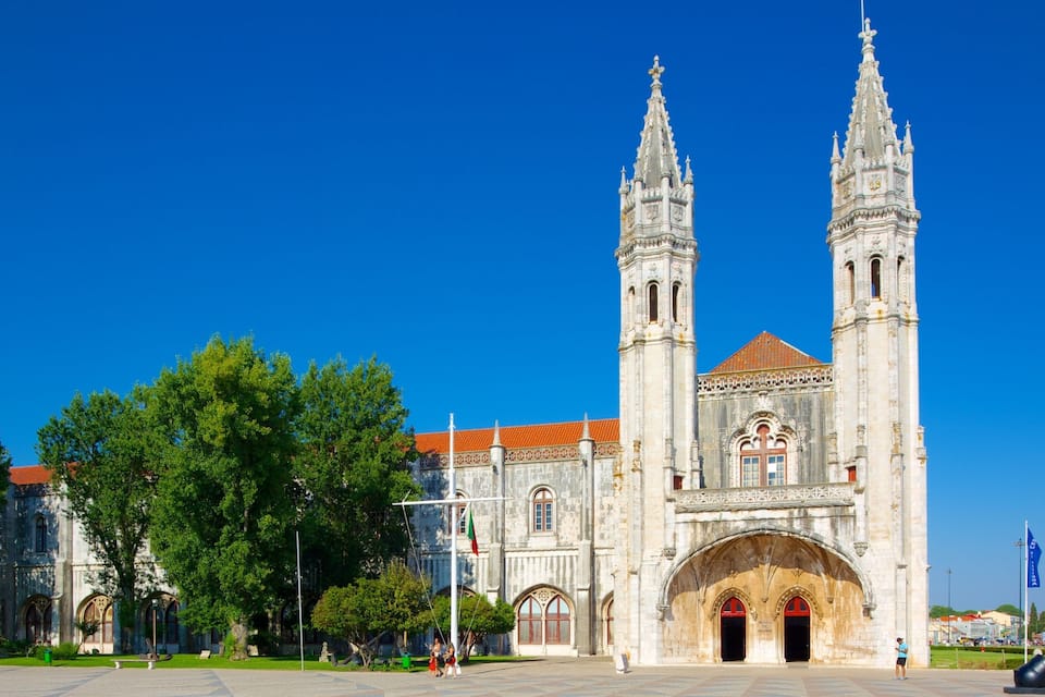 A historic cathedral with two tall towers and a red-tiled roof.