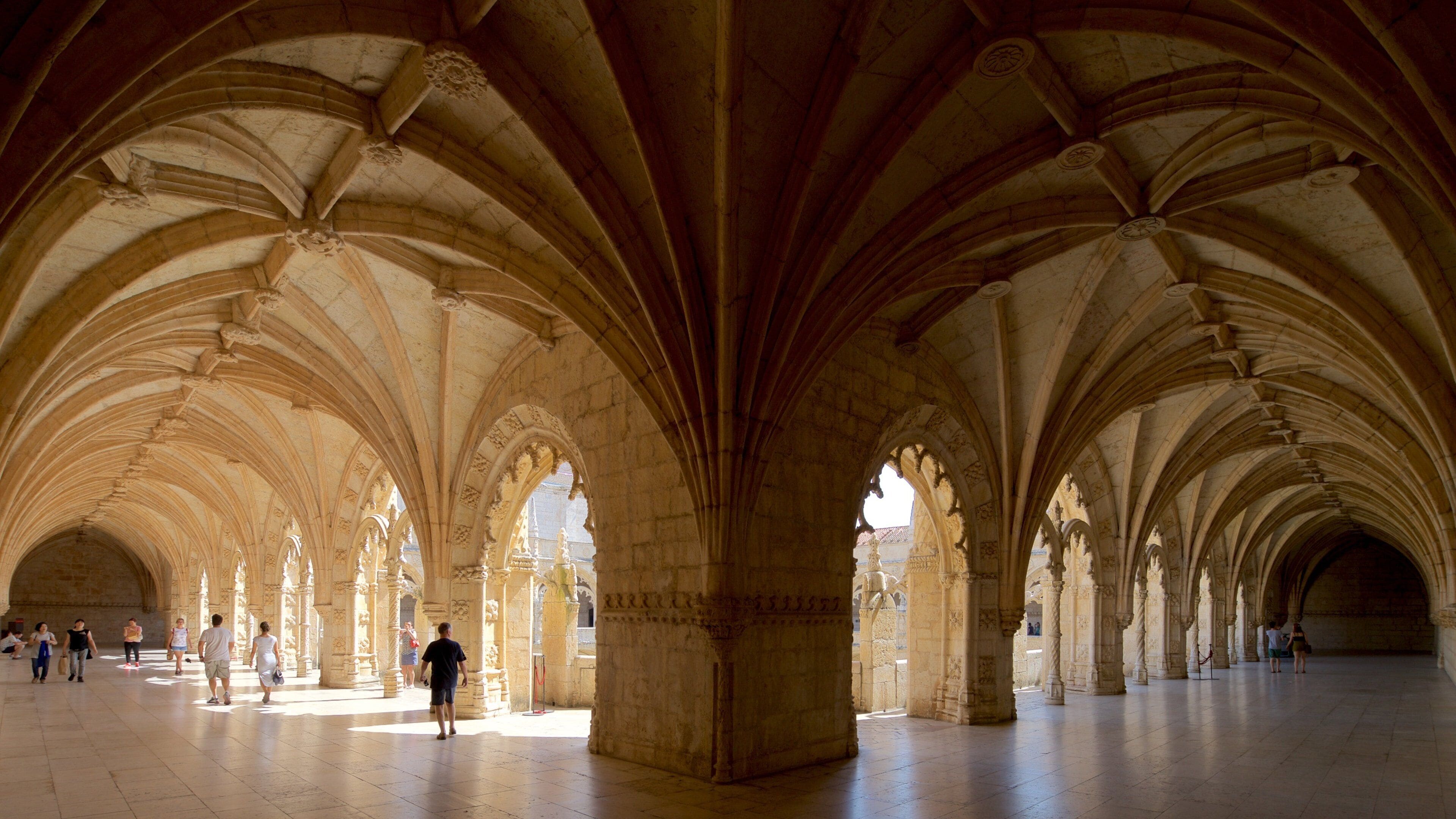 Jeronimos Monastery which includes interior views and heritage elements as well as a small group of people