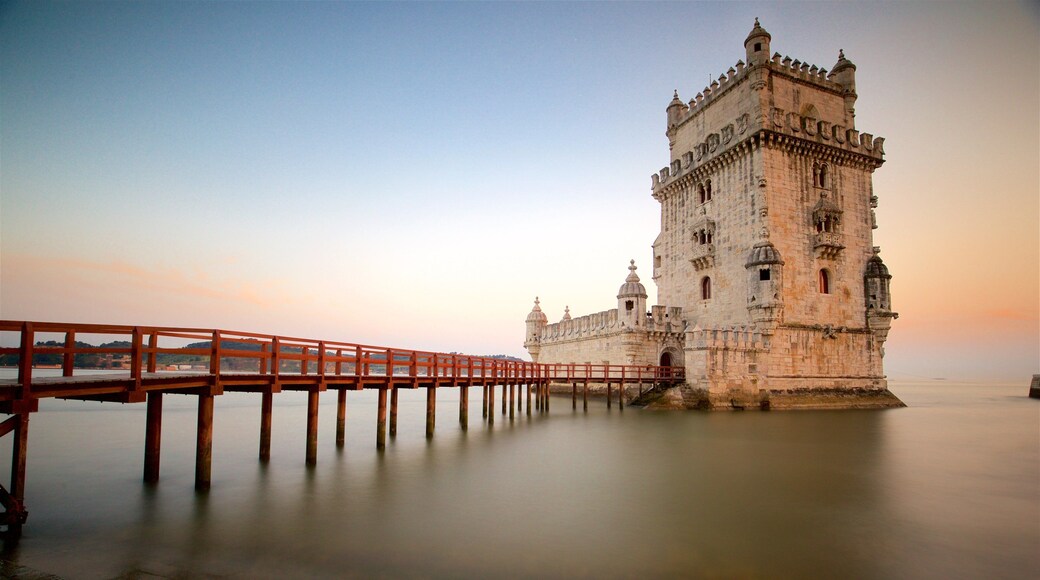 Belem Tower which includes a bridge, general coastal views and a sunset