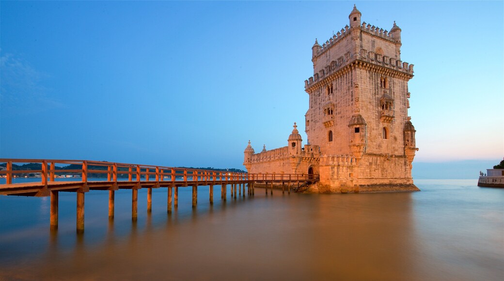 Belem Tower showing a lake or waterhole, a sunset and a bridge