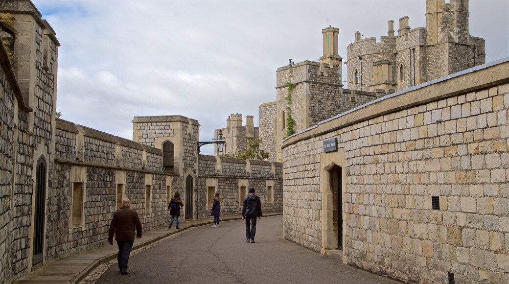 Windsor Castle featuring chateau or palace and heritage architecture as well as a small group of people