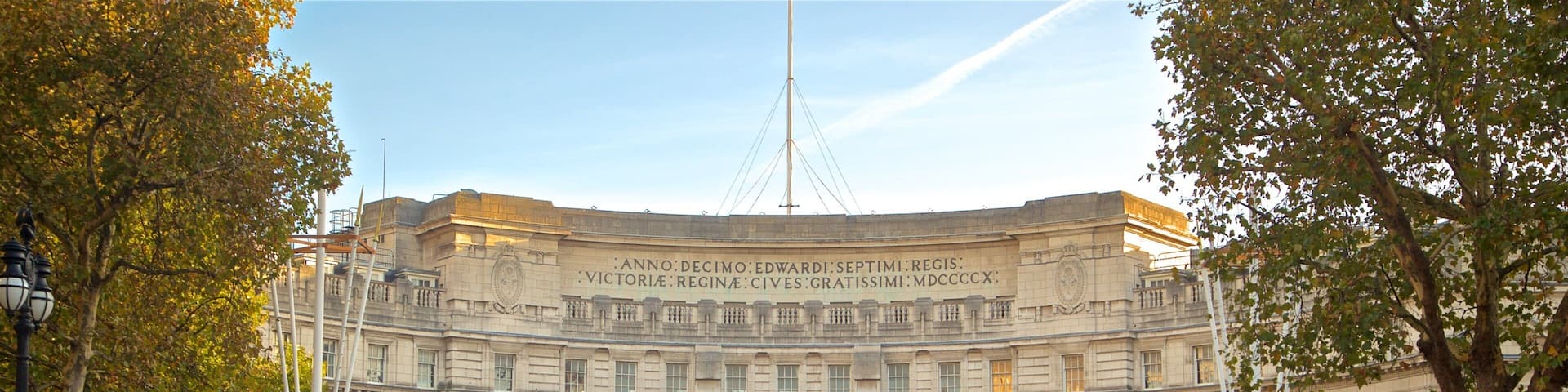 A grand building with large arches and a clock tower.