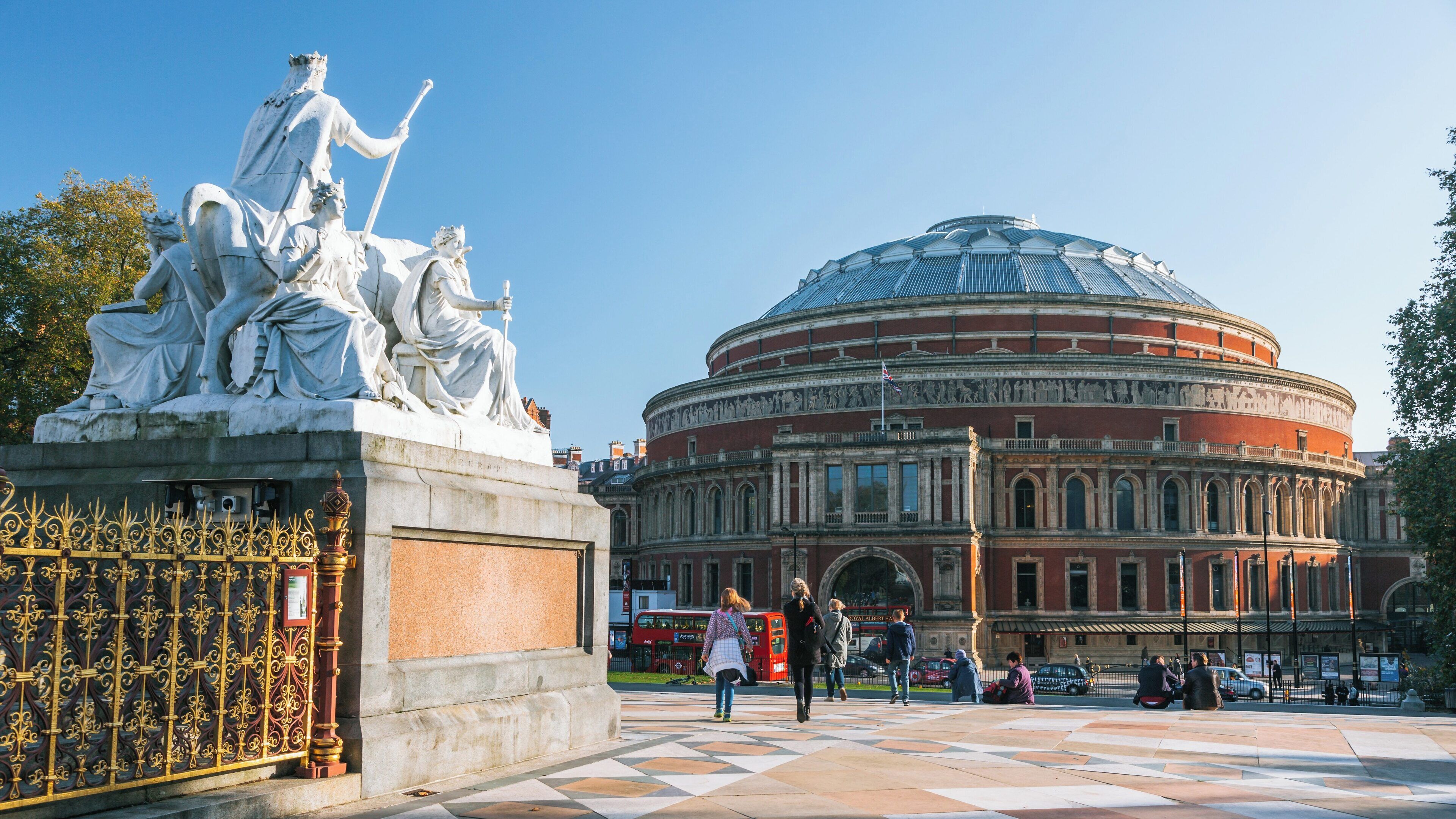 Royal Albert Hall showcased alongside classical sculptures in London, England on a clear day