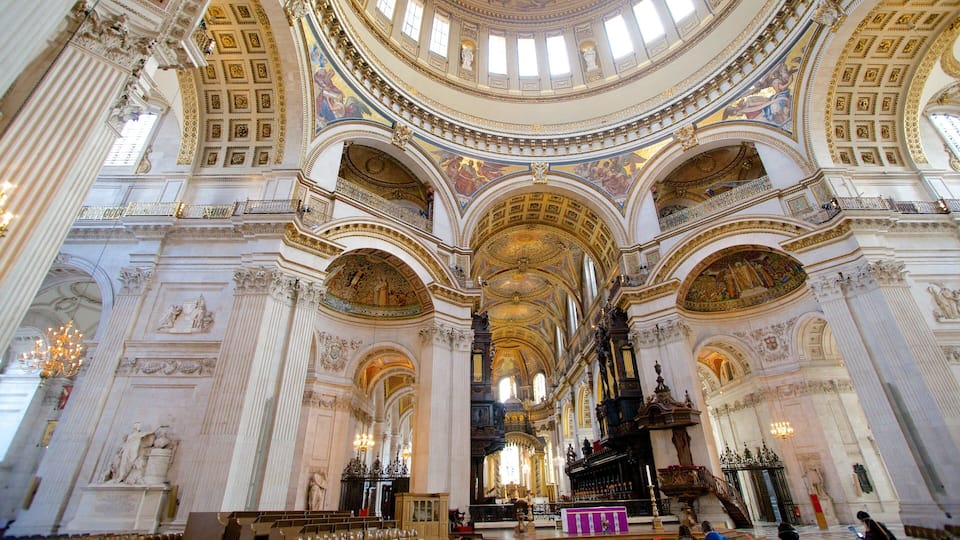 An ornate church interior with high ceilings, detailed frescoes, and classical architecture.