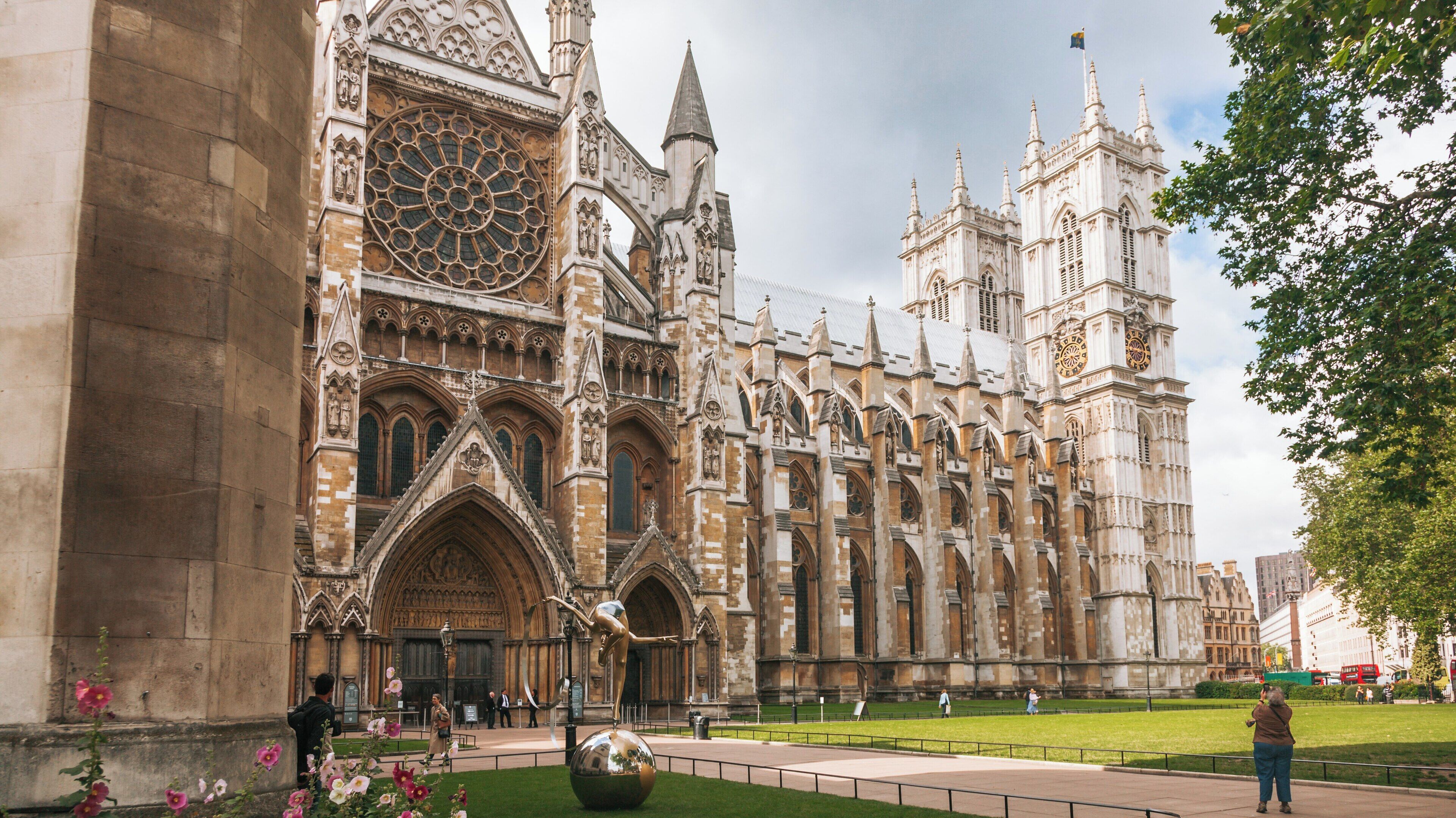 Westminster Abbey stands majestically in the City of Westminster showcasing its intricate architecture amid a serene park setting in London, England