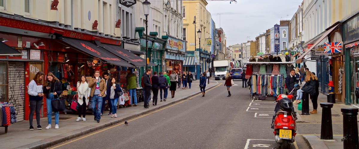 Portobello Road Market showing street scenes as well as a small group of people