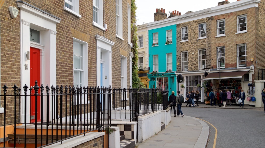 Portobello Road Market showing a house and street scenes as well as a small group of people
