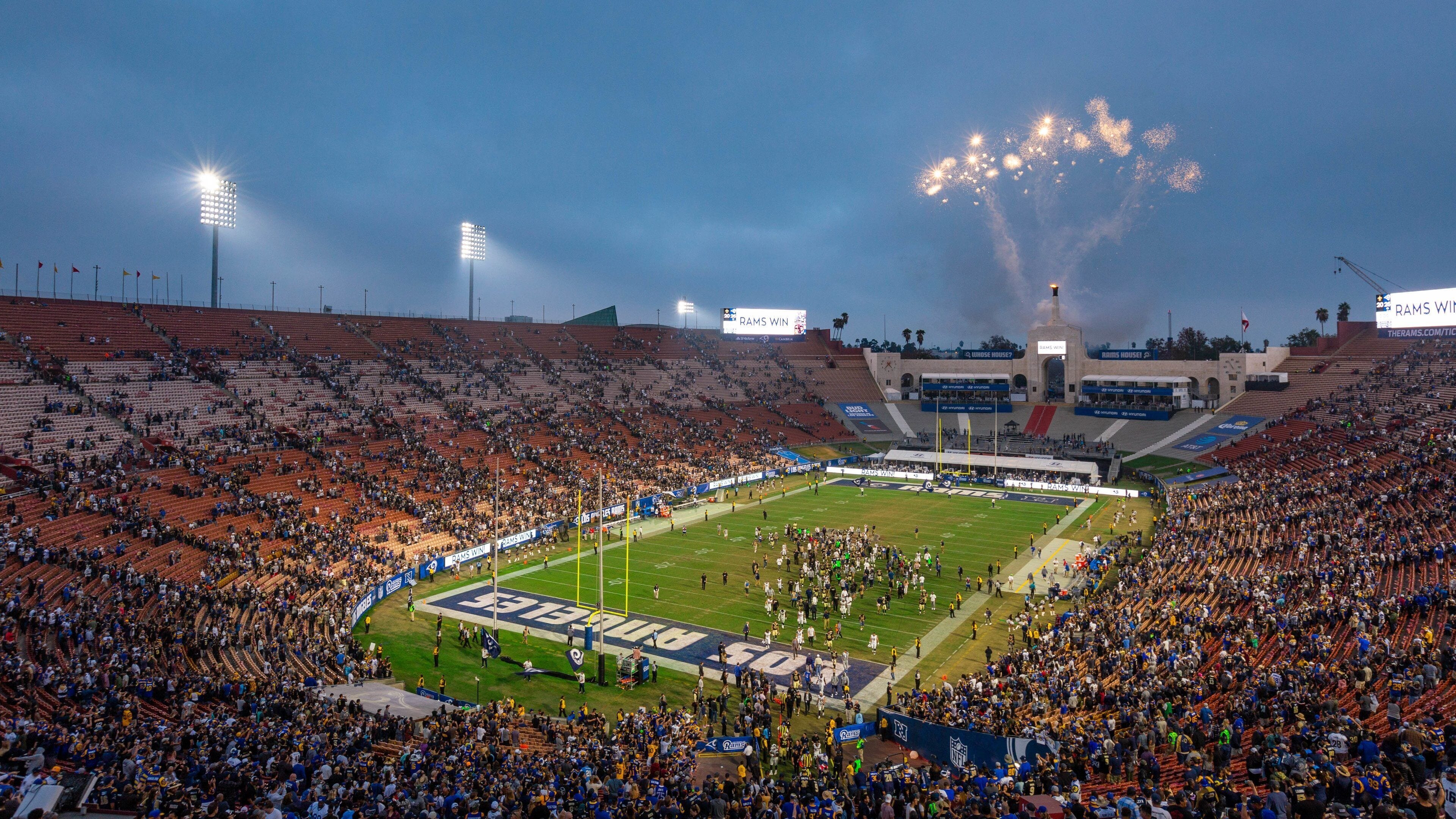 Los Angeles Memorial Coliseum which includes night scenes as well as a large group of people