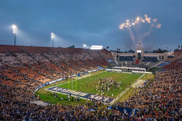 Los Angeles Memorial Coliseum which includes night scenes as well as a large group of people