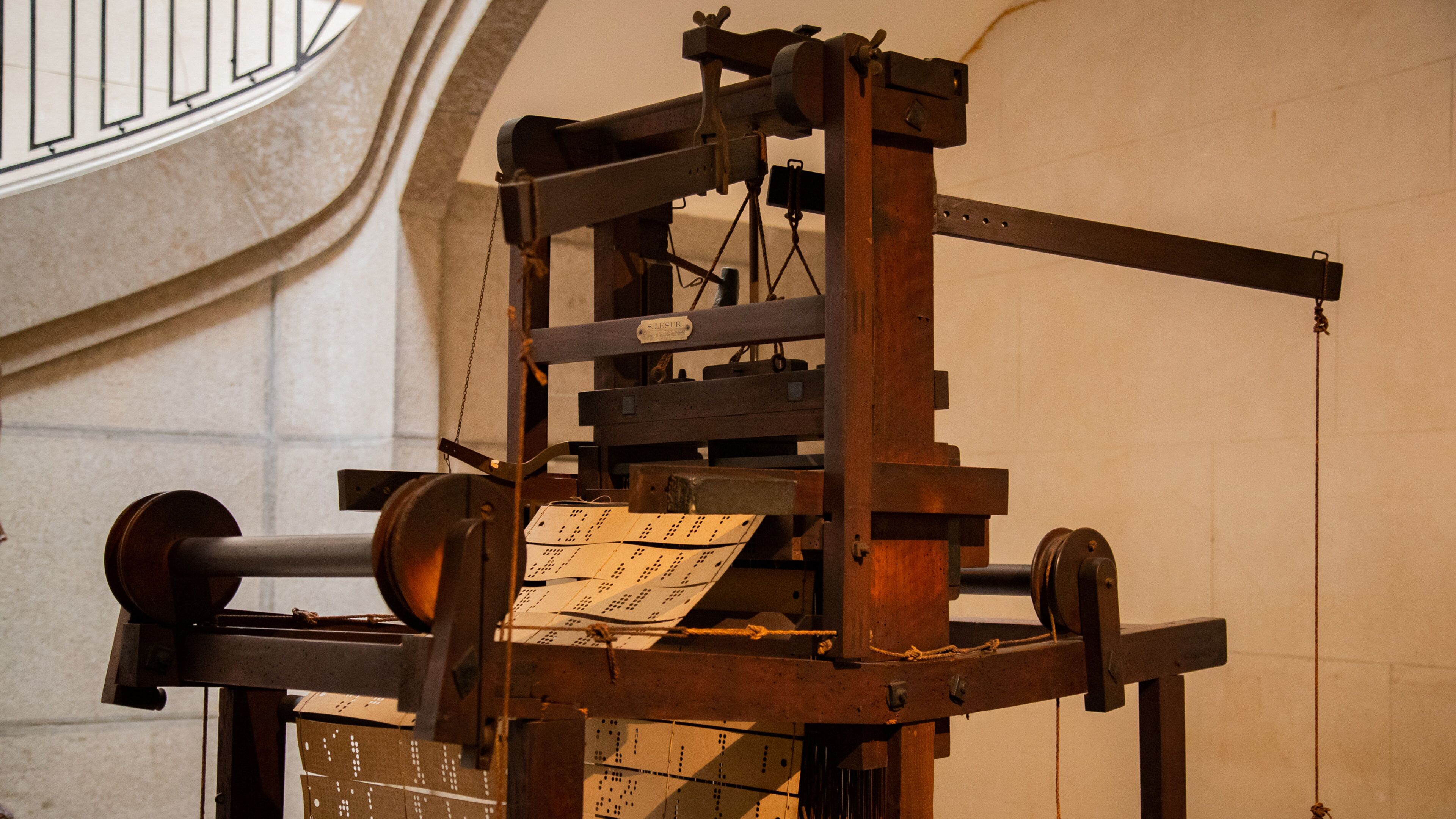 An old printing press with sheets of paper.