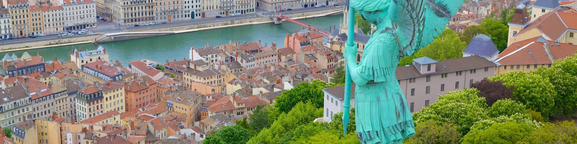 Basilica of Notre-Dame de Fourvière featuring a statue or sculpture and a city