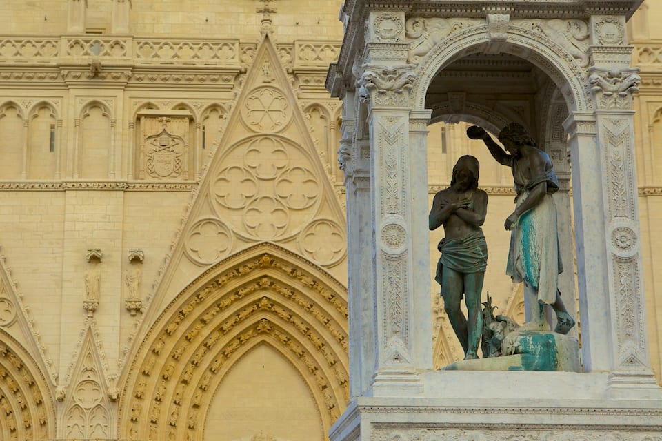 A Gothic-style cathedral facade with intricate stone carvings and statues.