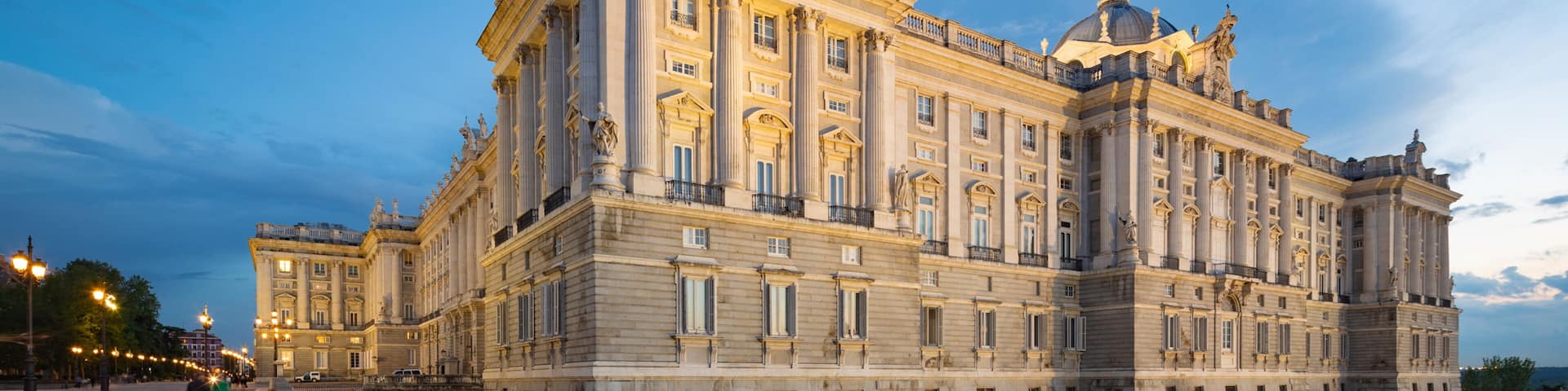 A grand historic building with classical architecture, featuring columns, statues, and a dome.