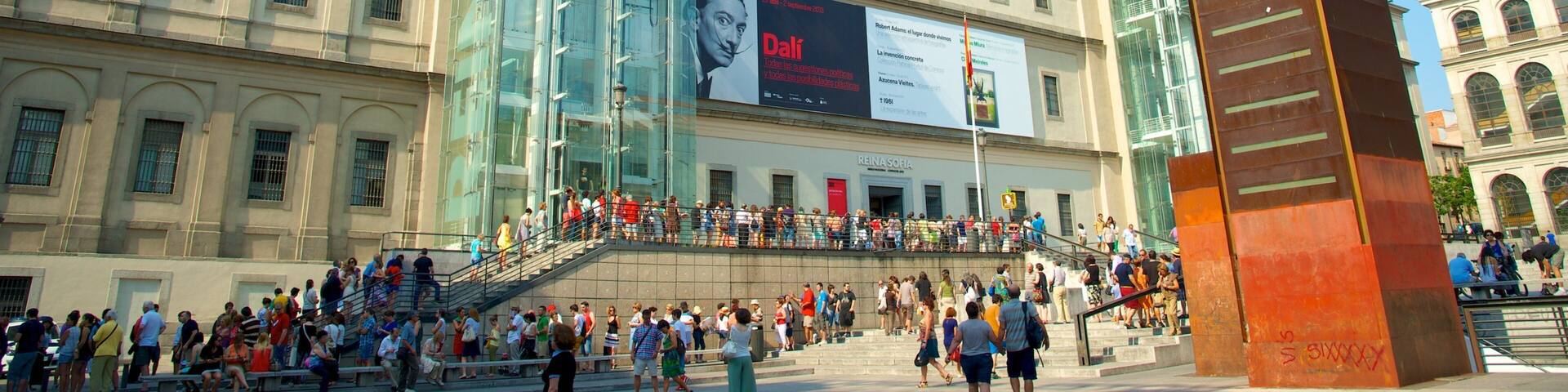 Reina Sofia Museum showing modern architecture and a square or plaza as well as a large group of people