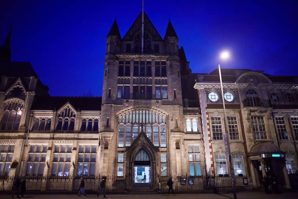 A historic building with Gothic architecture, large arched windows, and a prominent entrance.